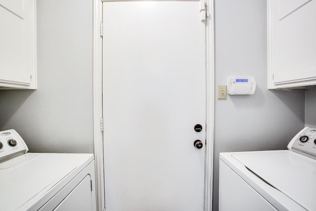 laundry area featuring cabinets and washing machine and clothes dryer