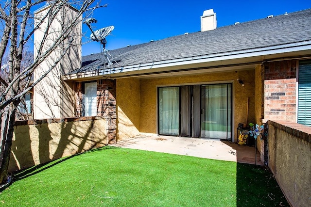 rear view of property featuring a yard and a patio