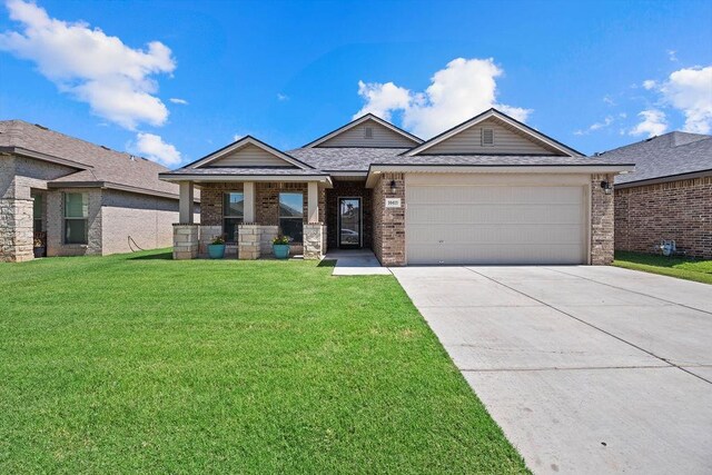 view of front of home featuring a garage, covered porch, and a front lawn