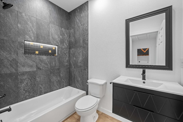 full bathroom with vanity, tiled shower / bath combo, toilet, and hardwood / wood-style flooring