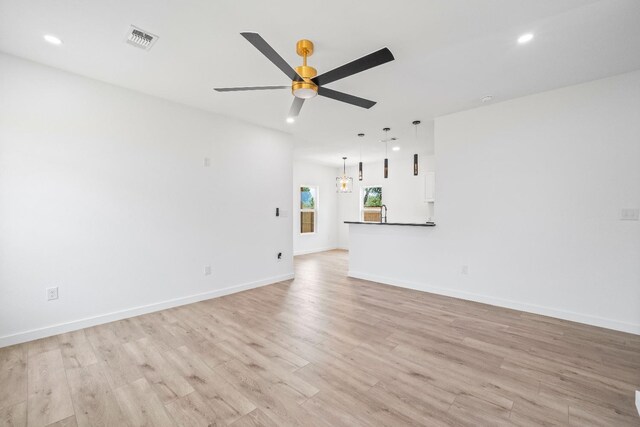 unfurnished living room with light hardwood / wood-style flooring and ceiling fan