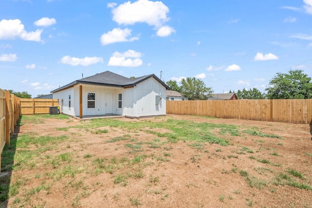 back of property with central AC unit and a patio