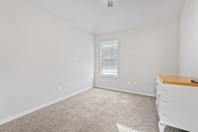 unfurnished room featuring ceiling fan, carpet flooring, and vaulted ceiling