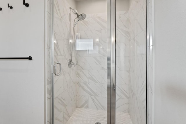 bathroom featuring a shower with shower door