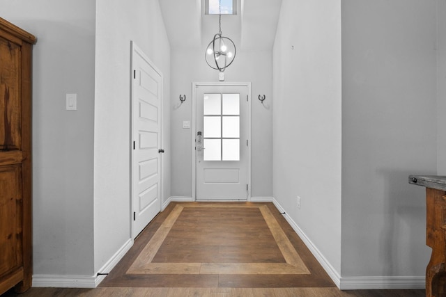 doorway featuring lofted ceiling and dark hardwood / wood-style flooring