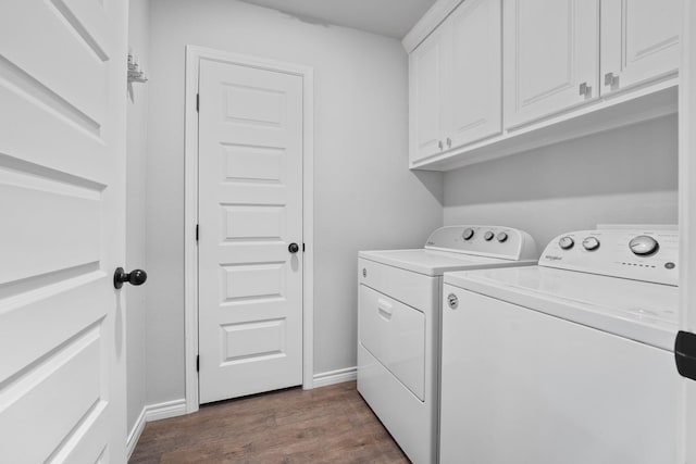 laundry area with cabinets, dark hardwood / wood-style floors, and washer and dryer