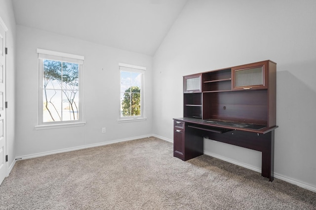 unfurnished office featuring vaulted ceiling and light carpet