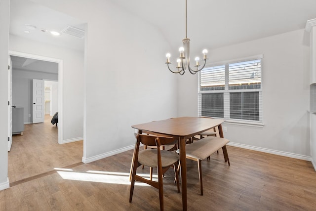 dining room with an inviting chandelier and light wood-type flooring