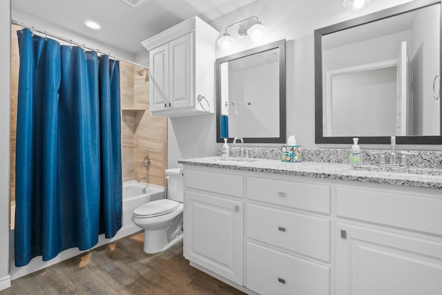 full bathroom featuring hardwood / wood-style flooring, vanity, toilet, and shower / bath combo with shower curtain