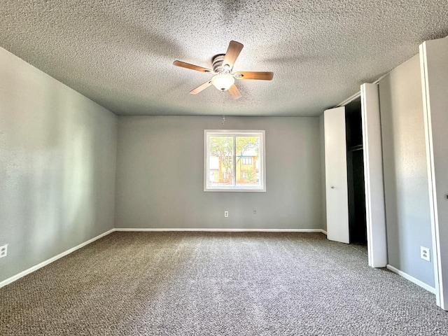 unfurnished bedroom featuring carpet, a textured ceiling, and ceiling fan