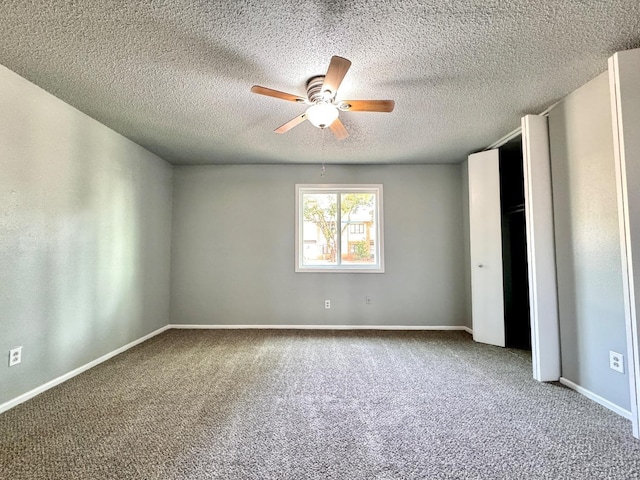 unfurnished bedroom featuring ceiling fan, carpet flooring, and a textured ceiling