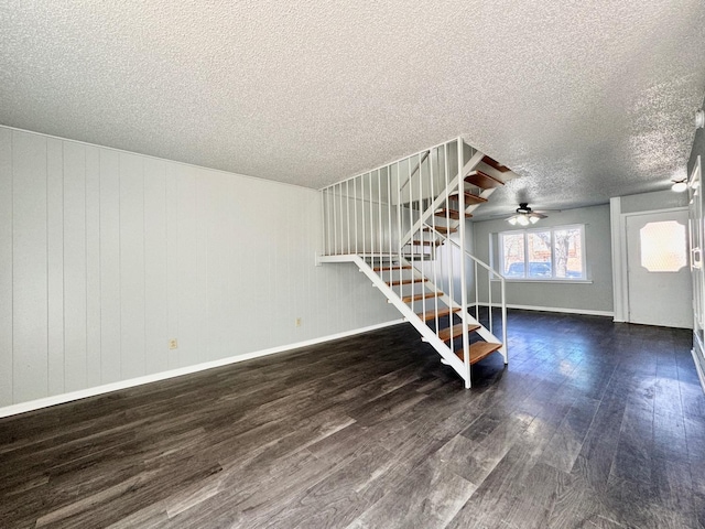 interior space featuring dark hardwood / wood-style flooring and a textured ceiling