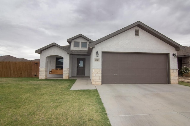 view of front of property featuring a garage and a front yard