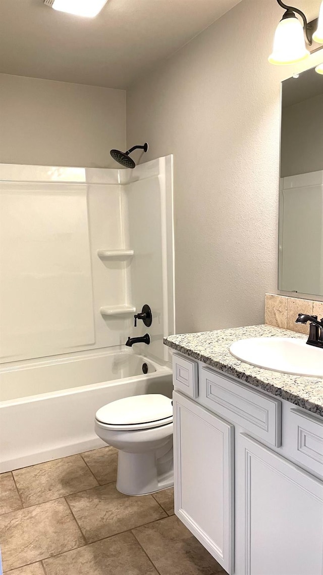 full bathroom with vanity, shower / bathtub combination, and toilet