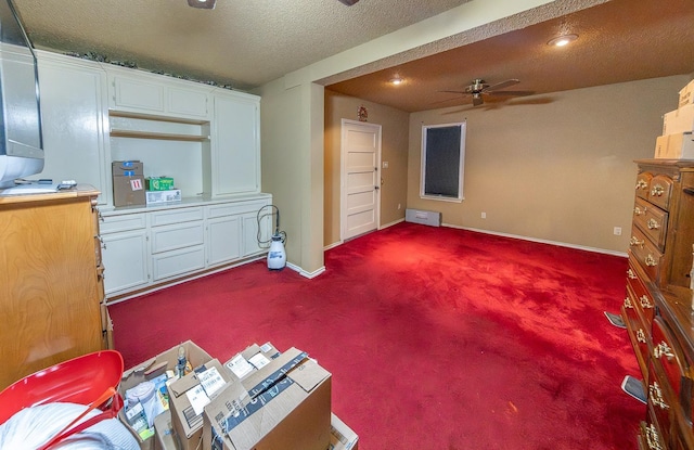 interior space with ceiling fan and a textured ceiling