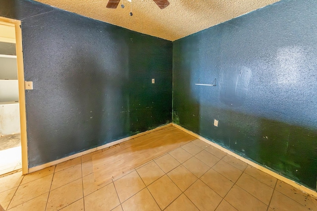 unfurnished room with tile patterned floors and ceiling fan