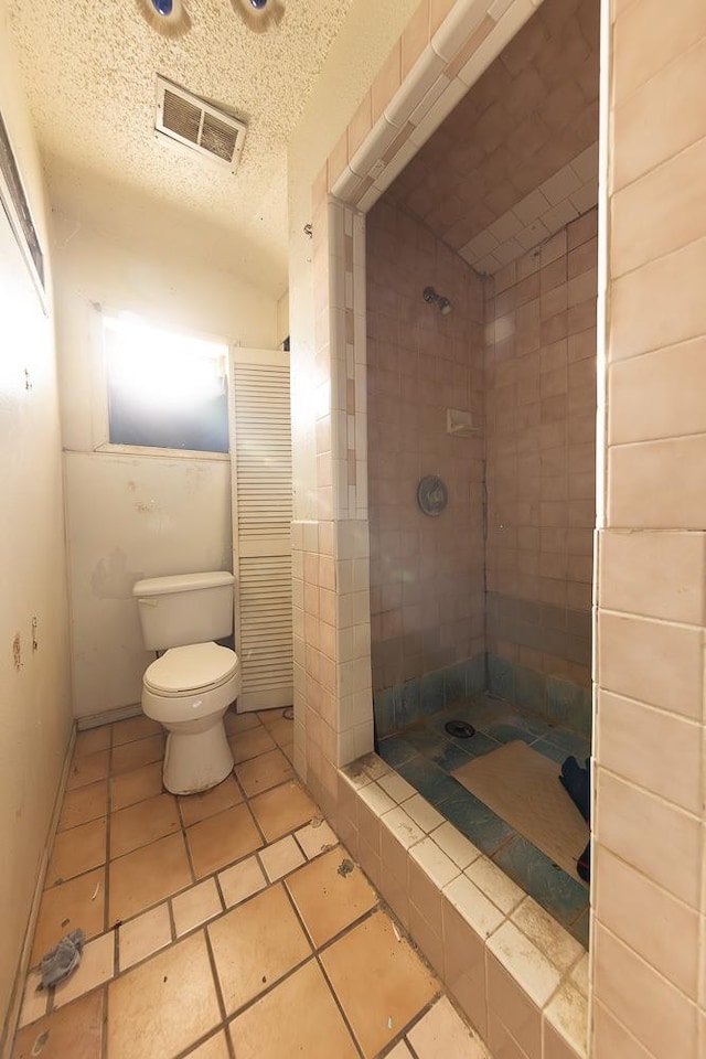 bathroom featuring a textured ceiling and toilet