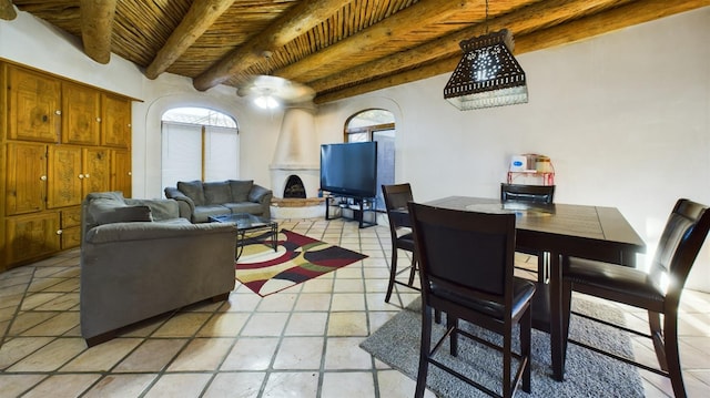 living room featuring a large fireplace, wooden ceiling, and beam ceiling