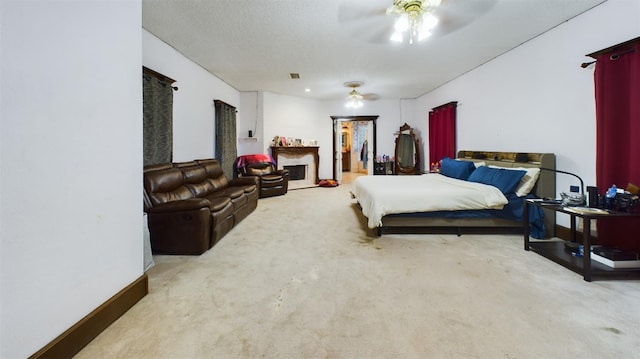 bedroom featuring ceiling fan, light carpet, and a textured ceiling