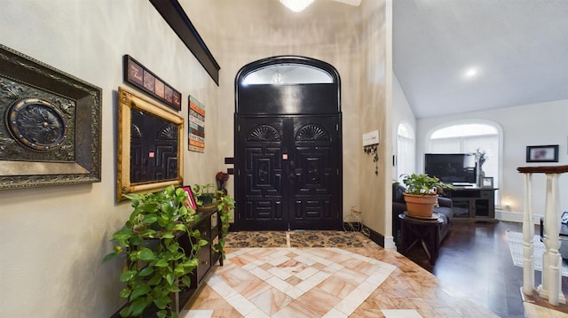 foyer featuring vaulted ceiling