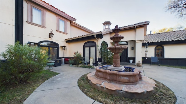 rear view of property with french doors and a patio