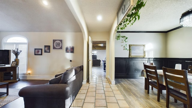 living room with light wood-type flooring and a textured ceiling