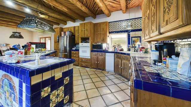 kitchen featuring appliances with stainless steel finishes, tile countertops, beamed ceiling, sink, and wood ceiling