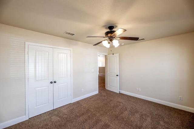 unfurnished bedroom featuring a closet, ceiling fan, and dark colored carpet