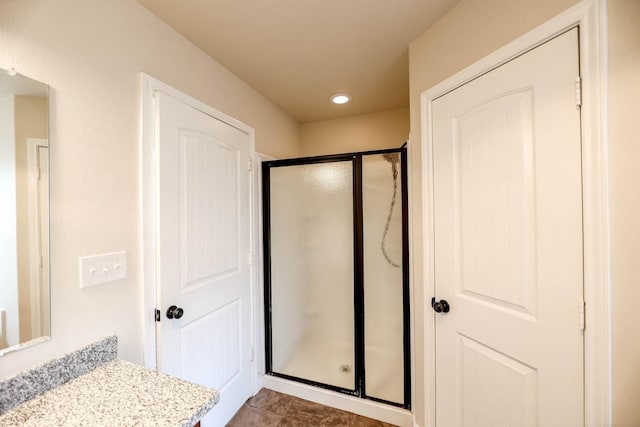 bathroom with a shower with shower door