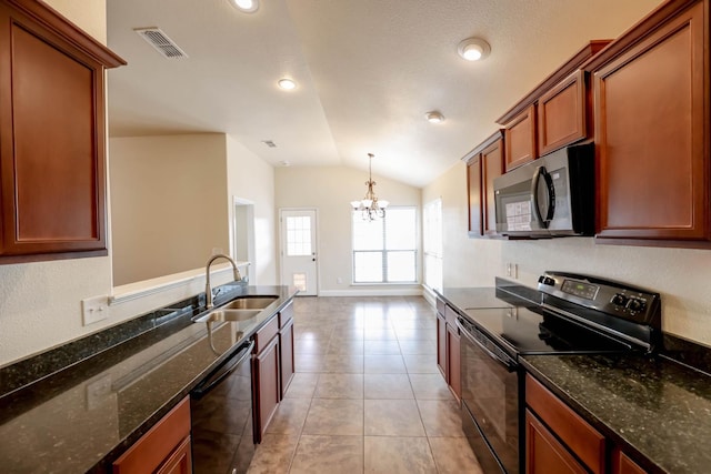 kitchen featuring lofted ceiling, sink, light tile patterned floors, black appliances, and dark stone counters