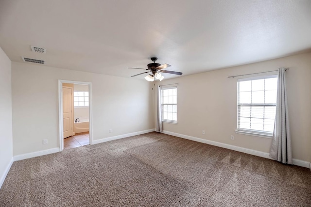 carpeted spare room with ceiling fan