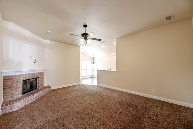 unfurnished living room featuring ceiling fan, lofted ceiling, a fireplace, and carpet floors