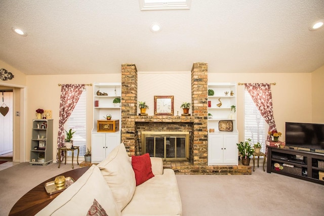 living room featuring a fireplace, carpet floors, and a textured ceiling