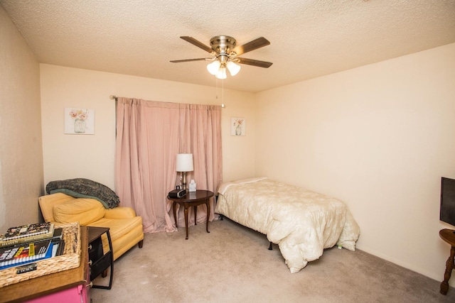 carpeted bedroom with a textured ceiling and ceiling fan