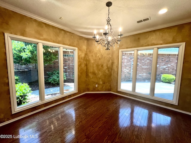 9802 Toledo Ave, Lubbock, TX 79424 - unfurnished room with dark wood-style flooring, a chandelier, a textured ceiling, and crown molding