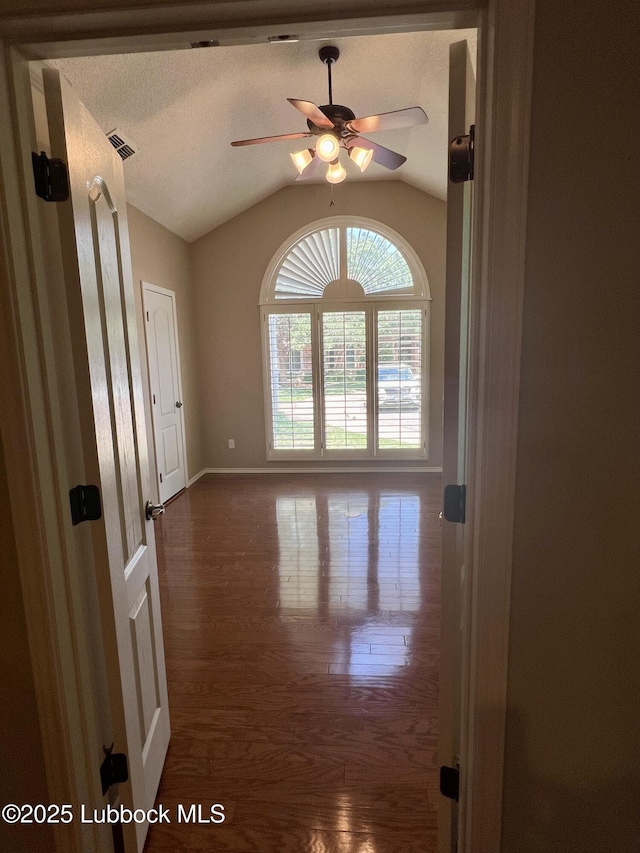 9802 Toledo Ave, Lubbock, TX 79424 - unfurnished room featuring lofted ceiling, a ceiling fan, and wood finished floors