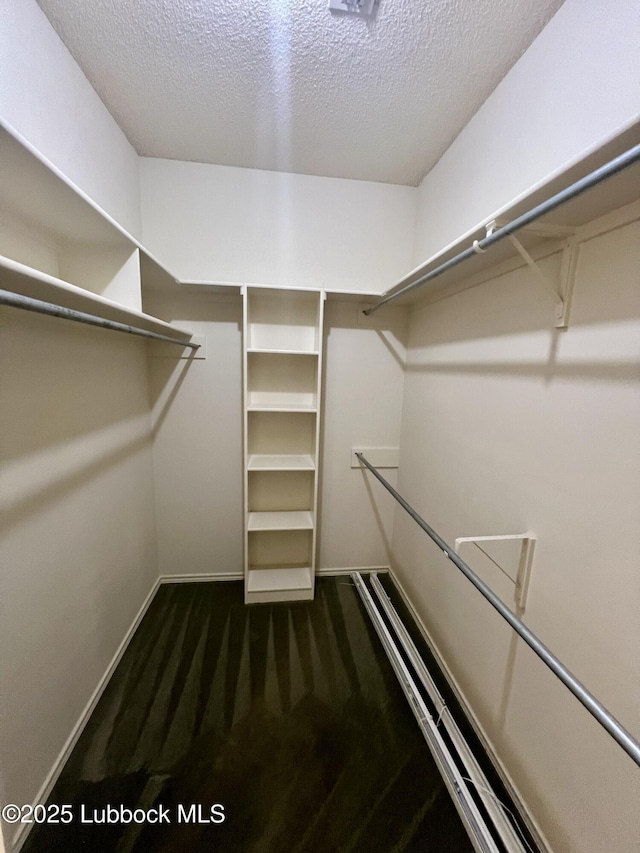 9802 Toledo Ave, Lubbock, TX 79424 - walk in closet featuring dark colored carpet