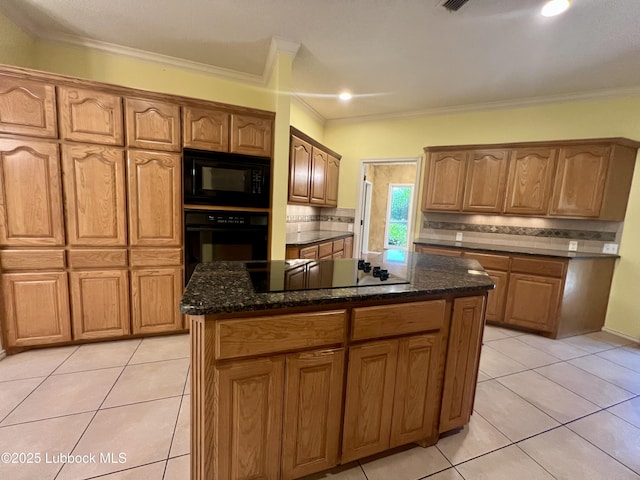 9802 Toledo Ave, Lubbock, TX 79424 - kitchen featuring black appliances, light tile patterned floors, a center island, backsplash, and dark stone counters