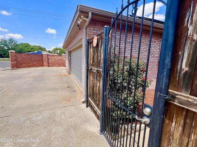 9802 Toledo Ave, Lubbock, TX 79424 - view of side of property featuring brick siding and a garage