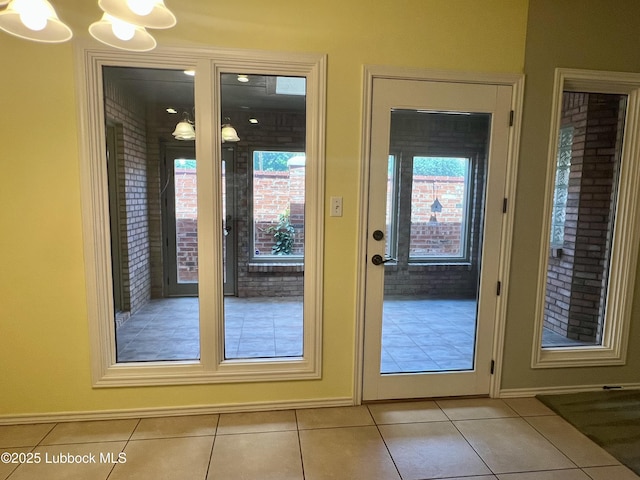 9802 Toledo Ave, Lubbock, TX 79424 - doorway featuring light tile patterned floors and a chandelier