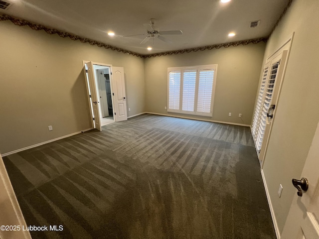 9802 Toledo Ave, Lubbock, TX 79424 - unfurnished bedroom featuring dark colored carpet and recessed lighting