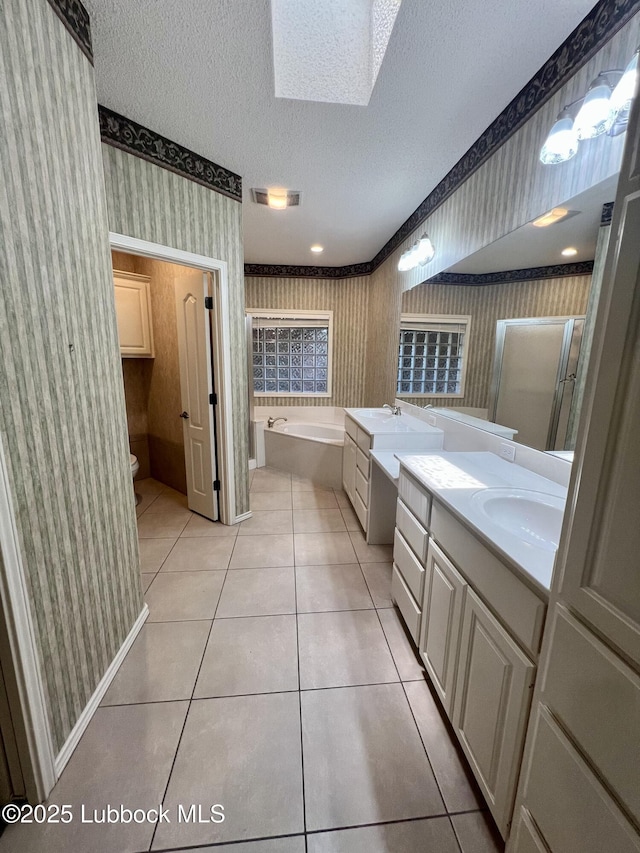 9802 Toledo Ave, Lubbock, TX 79424 - bathroom with wallpapered walls, tile patterned flooring, vanity, a garden tub, and a textured ceiling