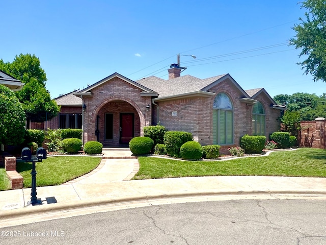 9802 Toledo Ave, Lubbock, TX 79424 - view of front facade featuring brick siding, a front lawn, a chimney, and roof with shingles