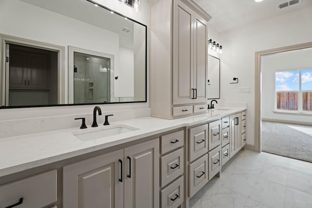 bathroom with vanity and a shower with shower door