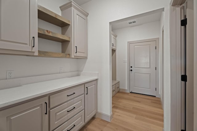 kitchen with white cabinets and light hardwood / wood-style flooring