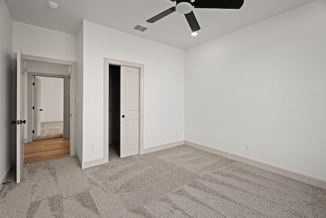 unfurnished bedroom with carpet, ceiling fan, and a closet