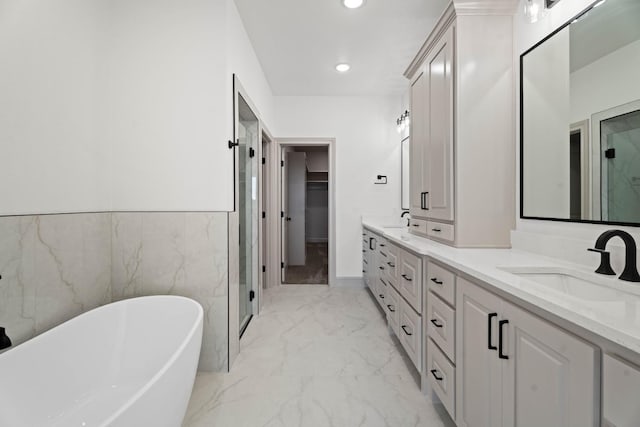 bathroom with vanity and independent shower and bath