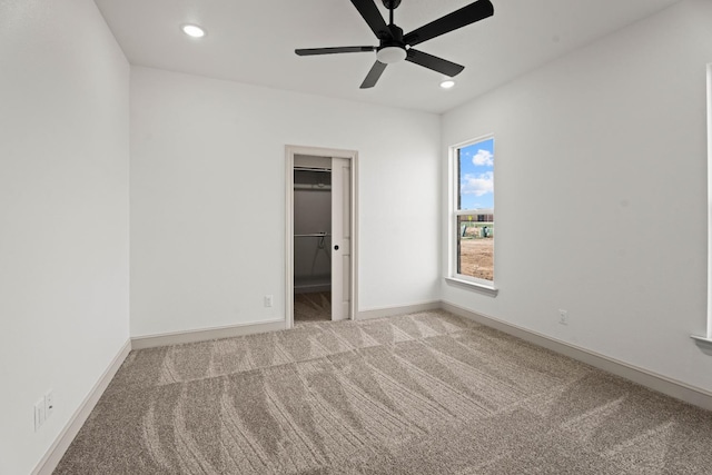 spare room featuring ceiling fan and carpet