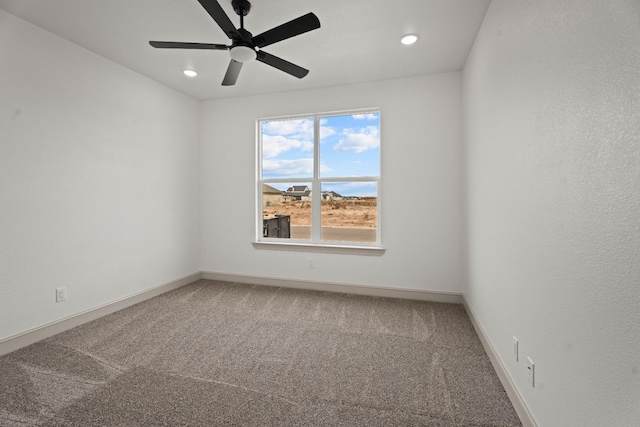 unfurnished room featuring ceiling fan and carpet