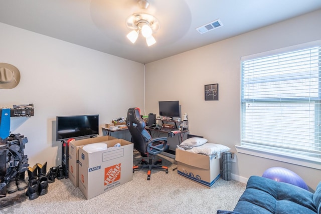 office space with ceiling fan, carpet floors, and a healthy amount of sunlight